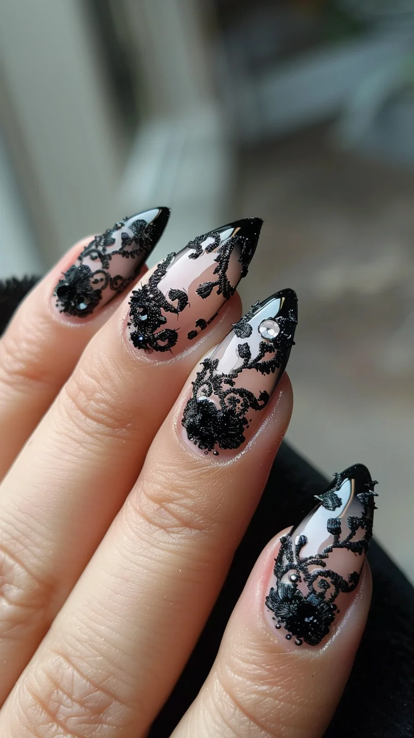 Featuring a nude base, these nails are adorned with detailed black lace patterns that include floral and swirl motifs. Small rhinestones are added for extra sparkle, enhancing the intricate design. The nails are stiletto-shaped, emphasizing the elegant and intricate lacework.