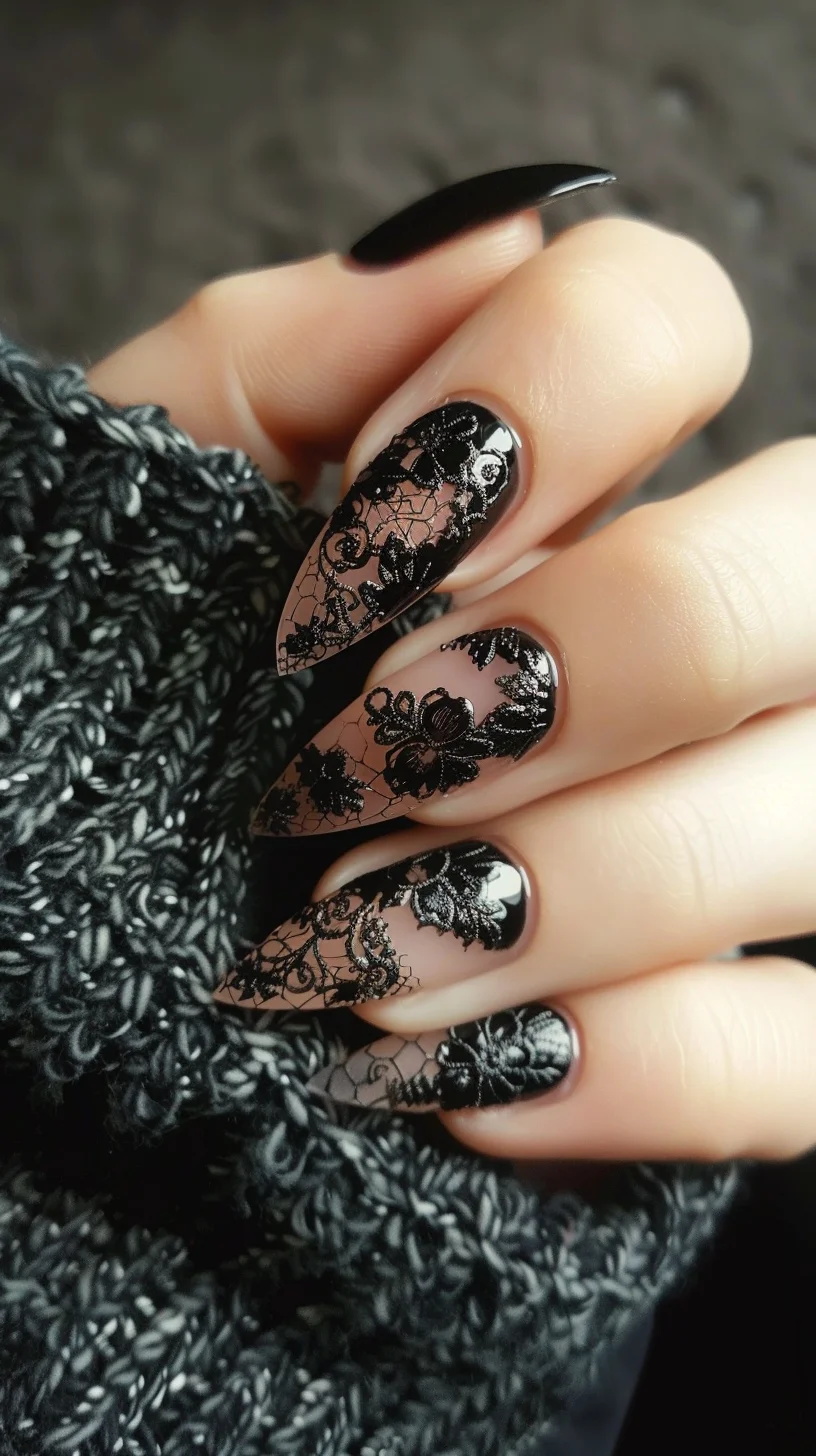 Almond-shaped nails feature a nude base with intricate black lace designs, including floral and swirl motifs. The lace adds an elegant touch, while the glossy black polish on some nails contrasts beautifully, enhancing the overall sophisticated look.