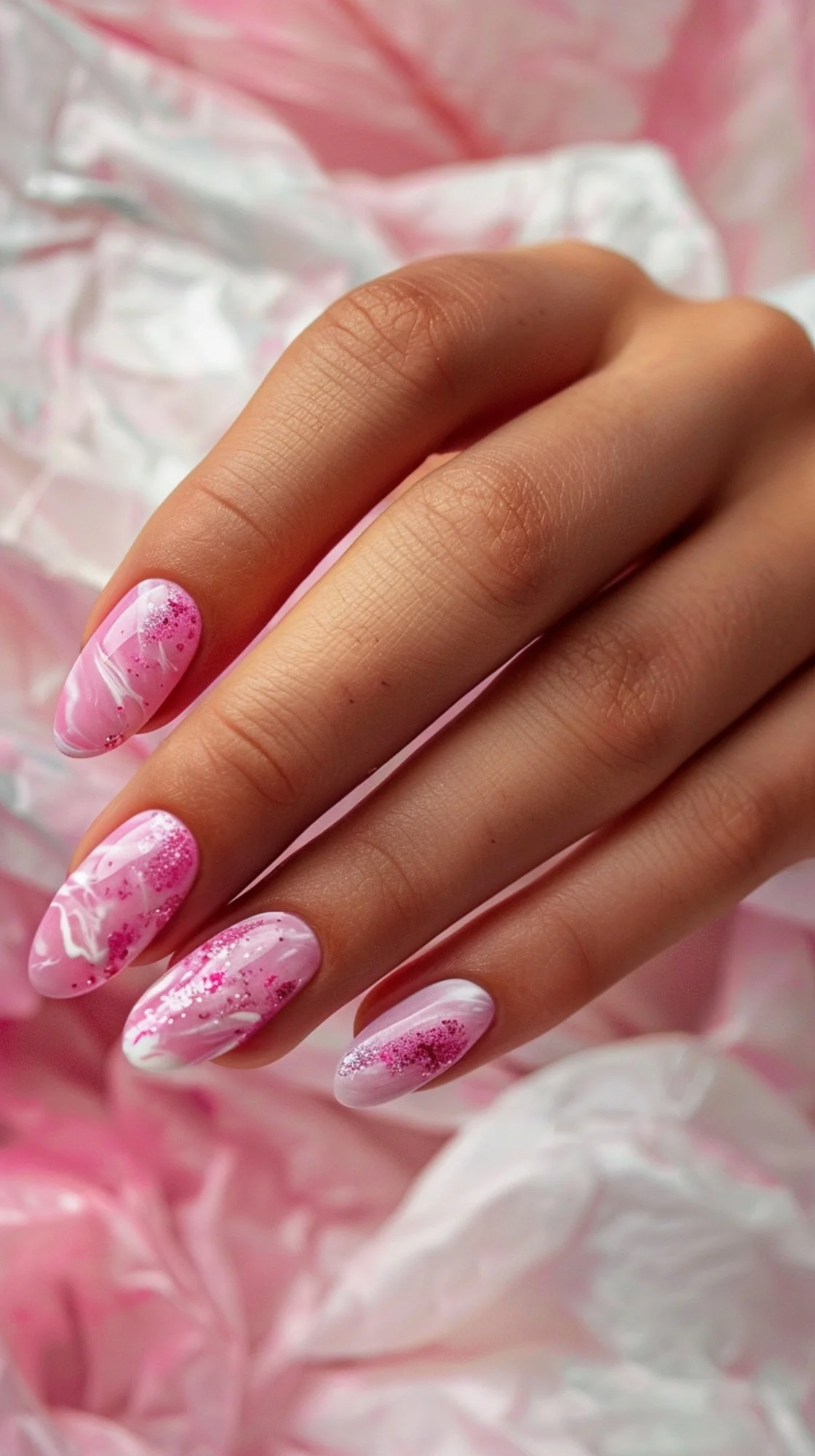 This nail design features a playful mix of pink hues and glitter. The marbled effect adds depth and interest, while the sparkles bring a fun and festive touch, making it perfect for celebrations and parties.