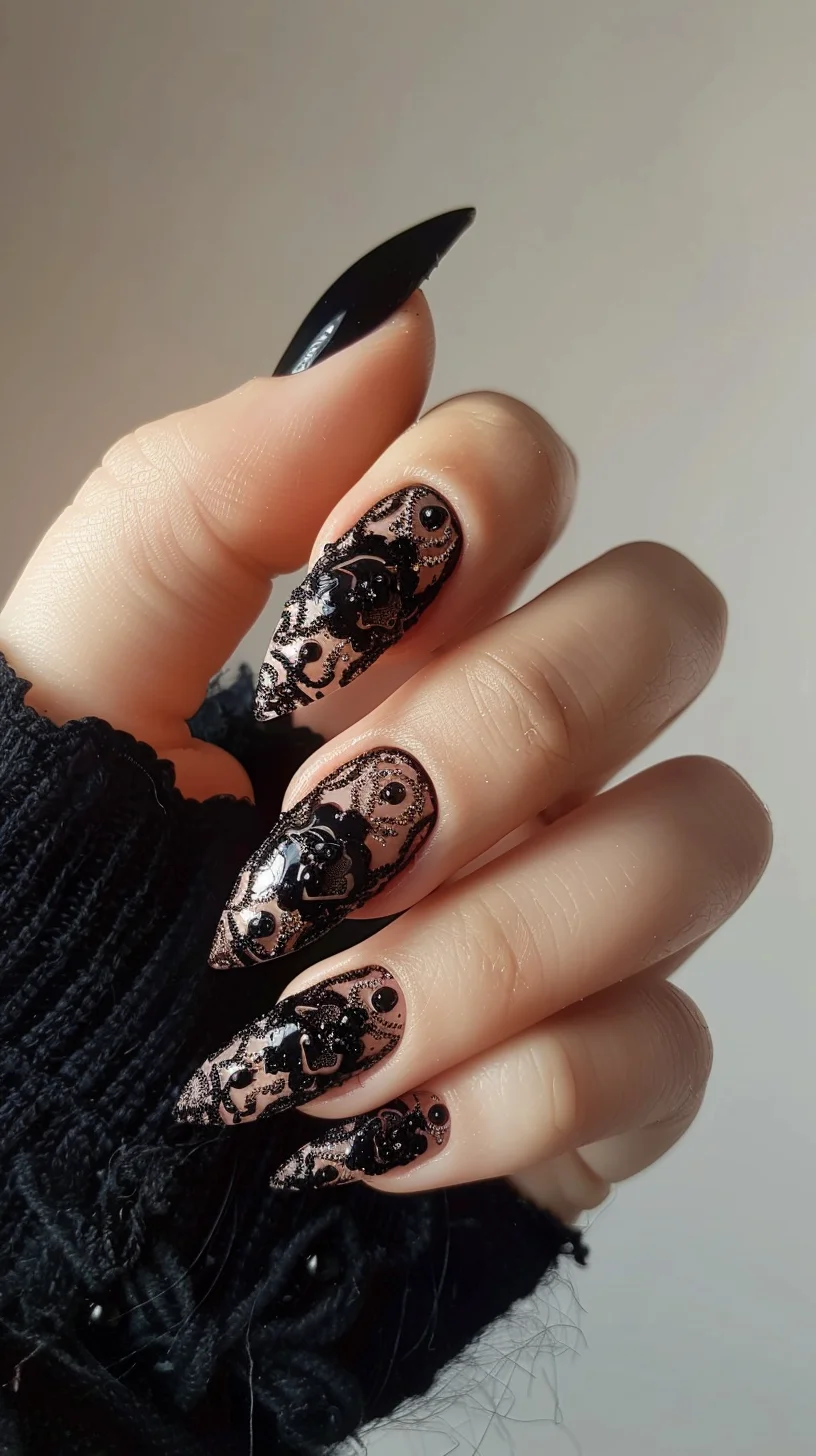 The nails present a black lace design over a nude base, creating a striking contrast. The lace patterns are ornate with floral and swirl elements, providing a vintage feel. The nails are long and pointed, enhancing the intricate lacework and giving a glamorous look.