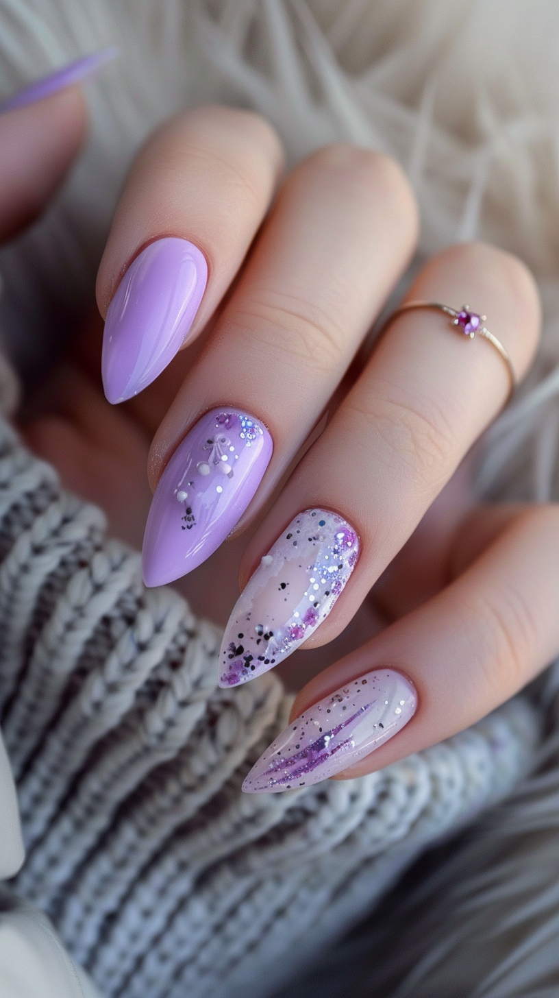Combining gloss and glitter, this design has a light purple base with various nails showcasing different glitter patterns. The playful use of glitter on different nails adds a fun and dynamic element to the design.