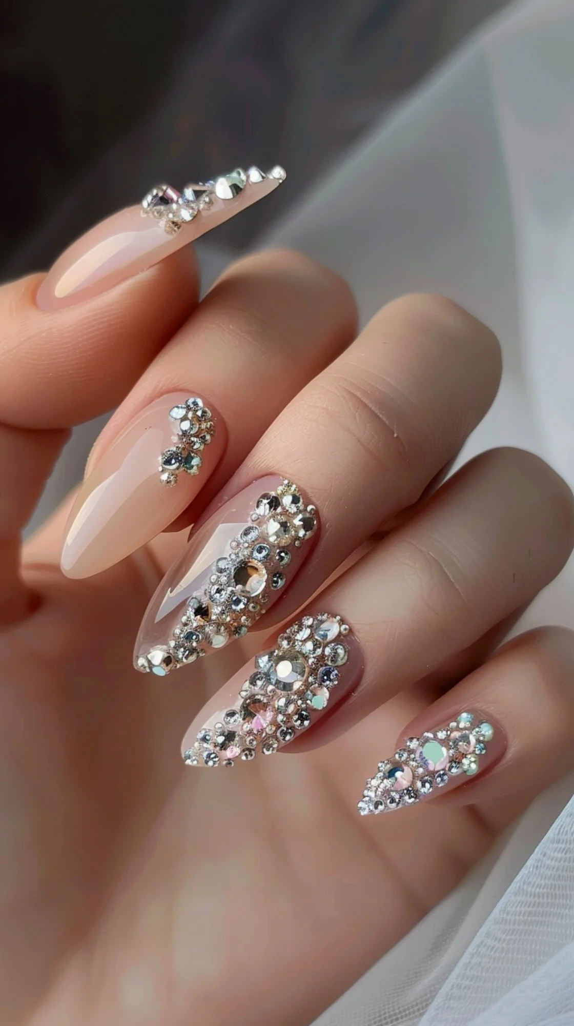 These nails feature a nude base adorned with clusters of shimmering crystals. The crystals are arranged to create intricate patterns, adding a touch of elegance and sparkle. This design is perfect for those who love a sophisticated yet glamorous look.