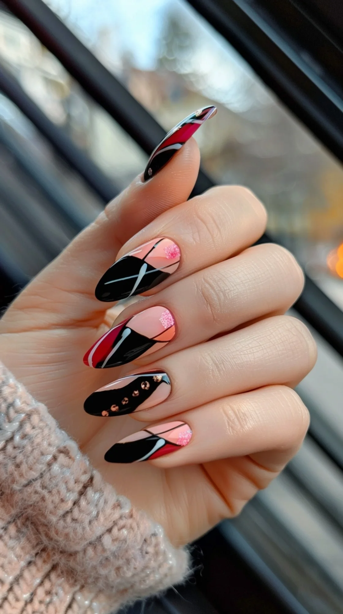 A striking combination of black, red, and pink, this nail art design incorporates bold lines and geometric shapes. The addition of glitter accents and rhinestones gives it a fun and edgy look, ideal for a night out.