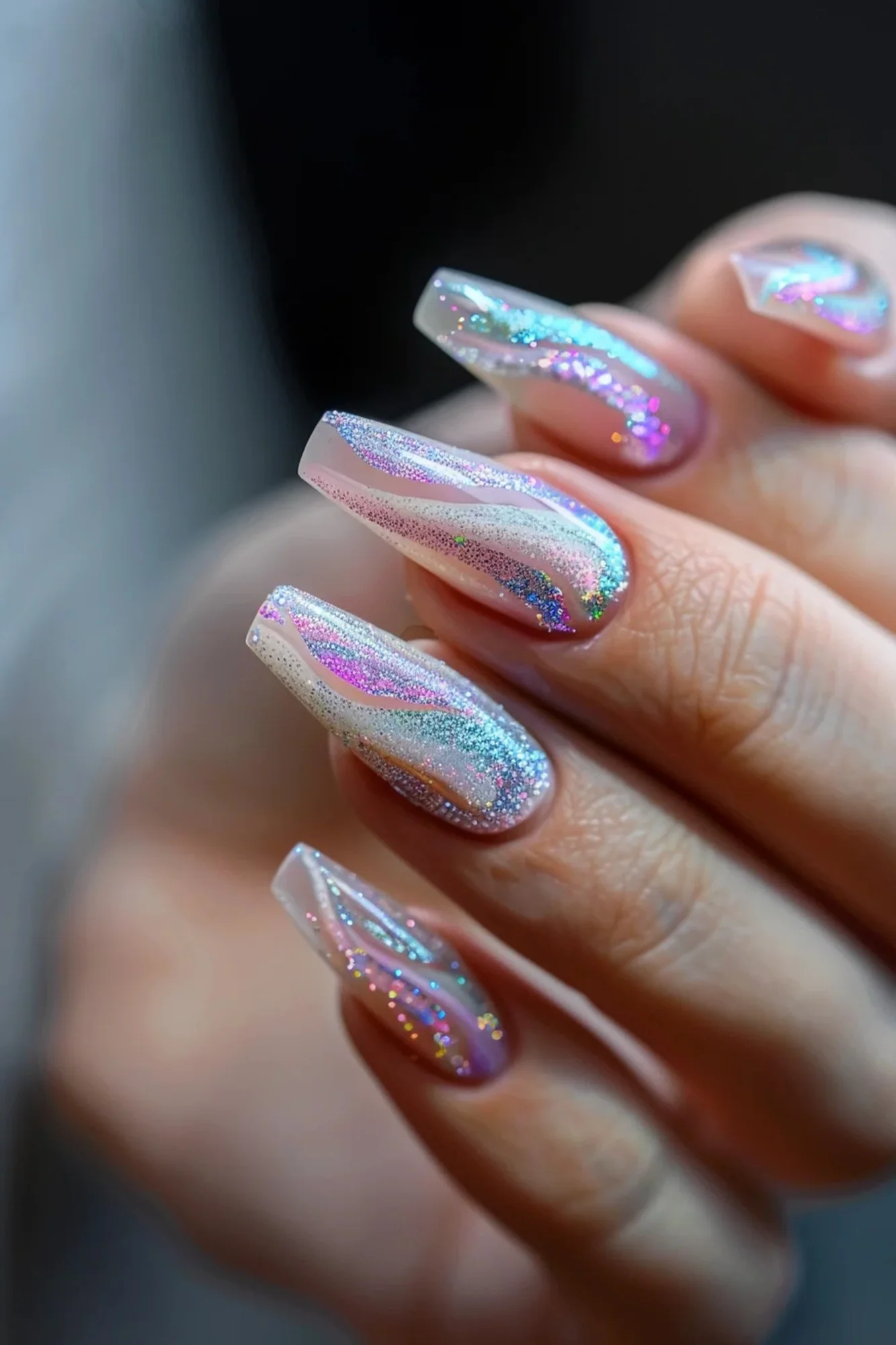 This design combines a holographic glitter with pastel shades, creating a dreamy, ethereal effect. The wavy lines and shimmering finish add a futuristic and stylish touch to your nails.
