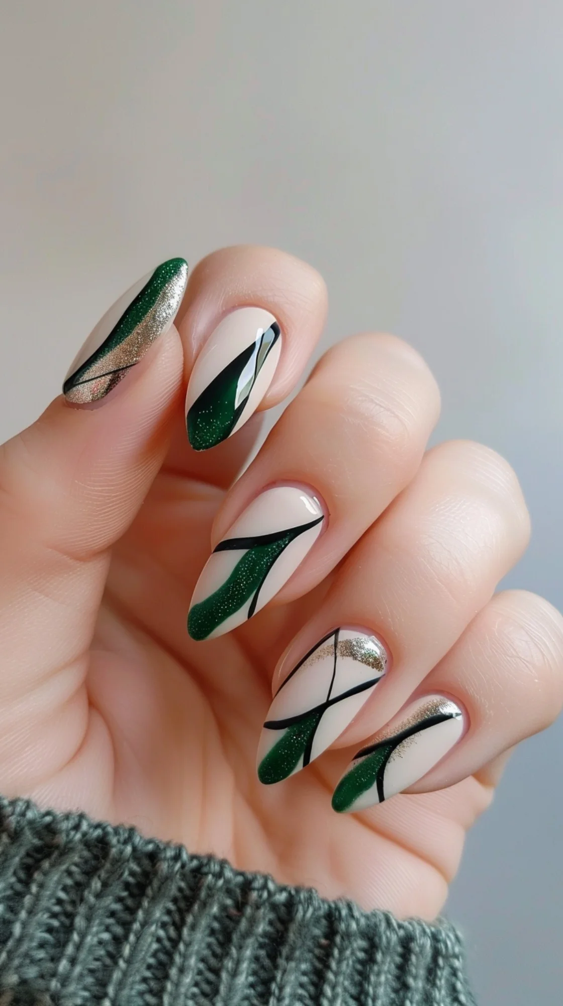 Green and silver lines create a fresh and modern design. The mix of dark green, silver, and white with sharp, clean lines makes this nail art suitable for both casual and formal occasions.