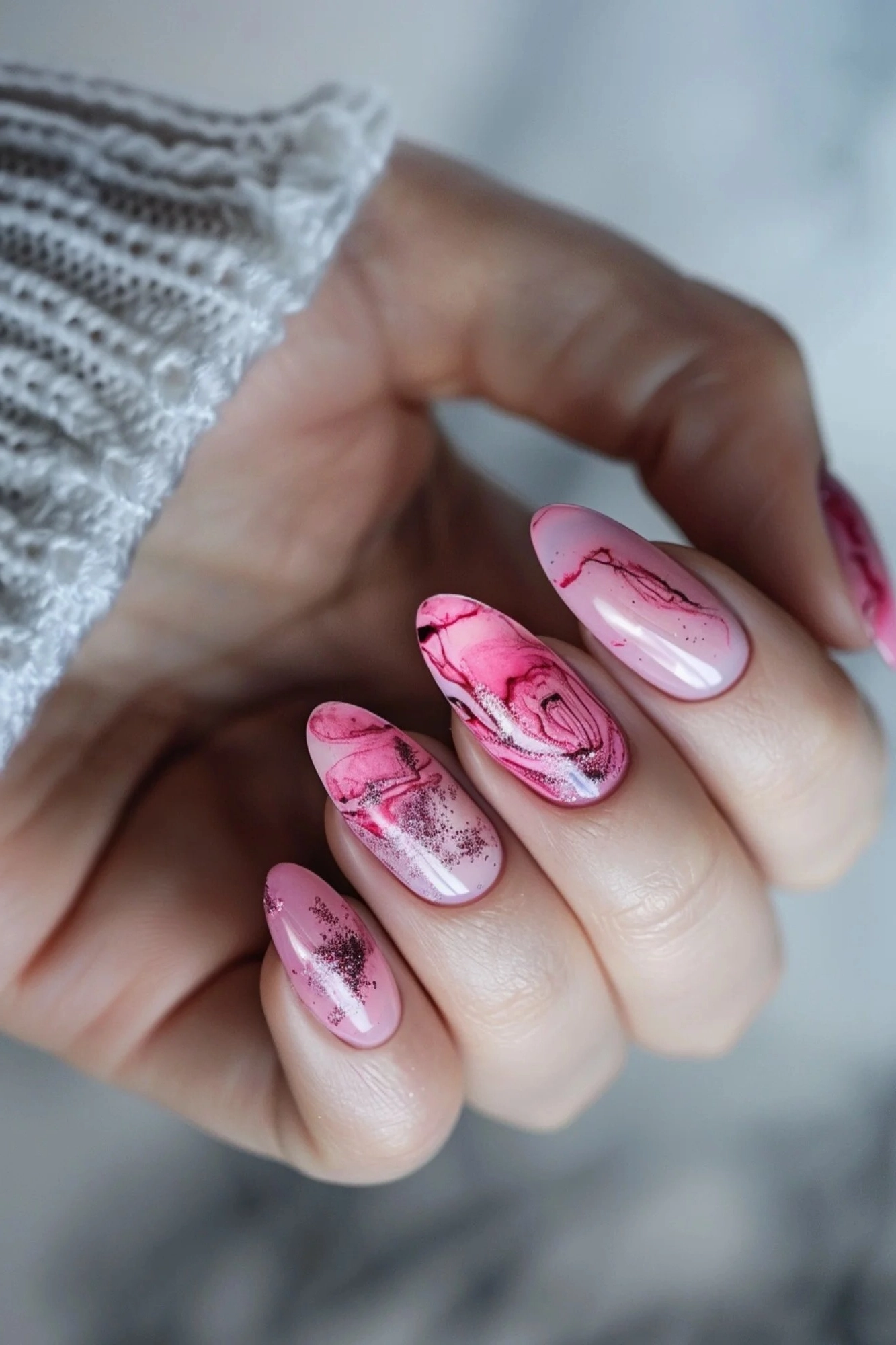 These nails showcase a soft pink base with intricate marbling and glitter details. The subtle shimmer enhances the overall design, making it perfect for those who love a touch of sparkle in their manicure.